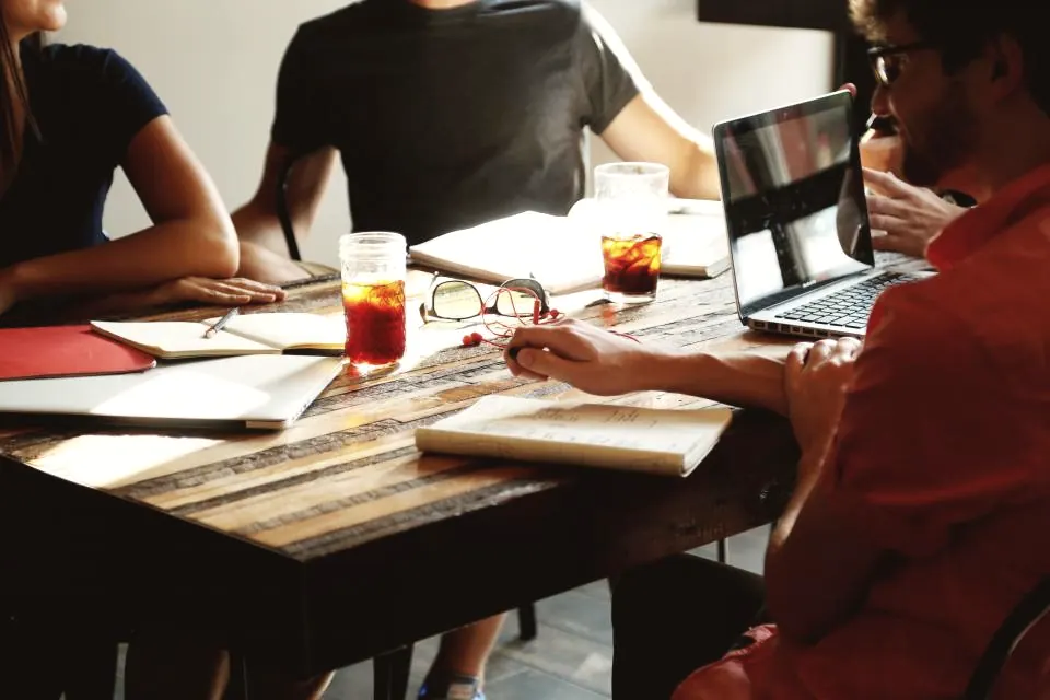 A team working together around a table with laptops